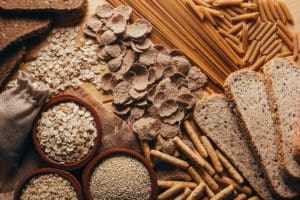 wooden table full of fiber rich wholegrain foods, perfect for a balanced diet